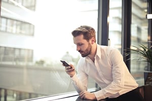 man looking at mobile device security